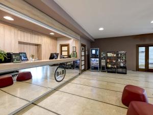 a hair salon with a counter and red chairs at B&B HOTEL Padova in Padova