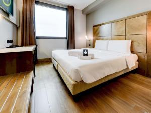 a hotel room with a large bed and a window at B&B HOTEL Padova in Padova +19 photos