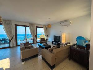 a living room with two couches and a television at Villa Sea Cliff 1 in Kyrenia