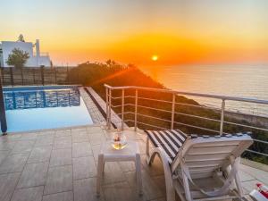a chair and a table next to a swimming pool at Villa Sea Cliff 1 in Kyrenia