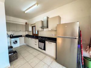 a kitchen with a stainless steel refrigerator at Villa Sea Cliff 1 in Kyrenia