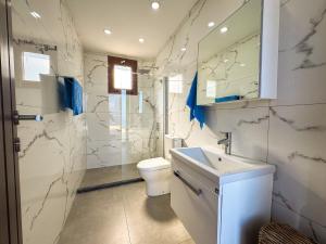 a bathroom with a toilet and a sink and a mirror at Villa Sea Cliff 1 in Kyrenia +16 photos