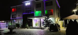 Un edificio con luces de colores por la noche. en Merrigold Resorts, en Gbogije 6 fotos más