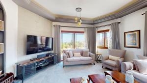 a living room with a couch and a tv at Villa Dunya in Kyrenia