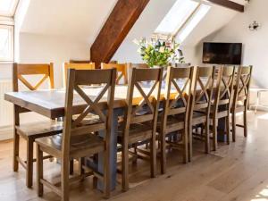 a dining room with a wooden table and chairs at Bedw Barn in Newtown