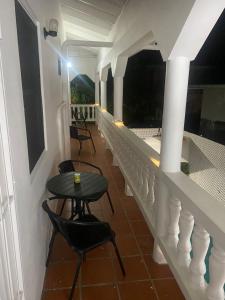 a balcony with a table and chairs on it at The Sky High Escape - 5 Mins from Airport & Beaches in Bon Accord