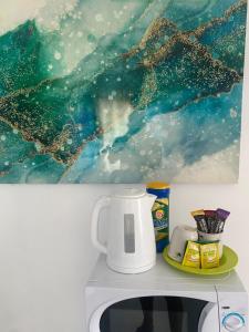 a coffee maker on top of a microwave at The Sky High Escape - 5 Mins from Airport & Beaches in Bon Accord +7 photos