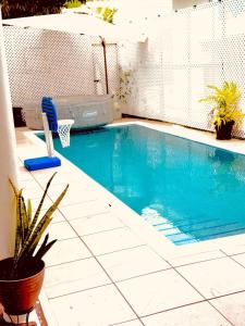 a swimming pool with a basketball hoop at The Sky High Escape - 5 Mins from Airport & Beaches in Bon Accord