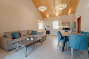 a living room with a couch and a table at Pithari Stone Villa in Khalikerí