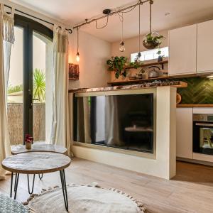 ラ・シオタにあるMon petit cocon au bord de l'eauの大型薄型テレビのあるリビングルーム