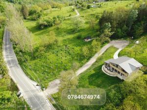 an aerial view of a house with a road at Zamura in Bozioru