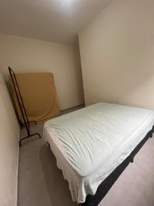 Ένα ή περισσότερα κρεβάτια σε δωμάτιο στο Casa São Vicente - 10 min from Praia Grande Ocean