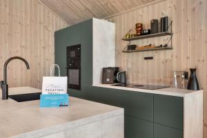 a kitchen with a counter with a sign on it at Trysil hytteomrade 2041 by Vacation Trysil in Hovi