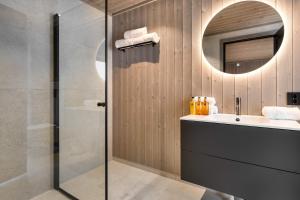 a bathroom with a sink and a mirror at Trysil hytteomrade 2041 by Vacation Trysil in Hovi