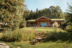 a log cabin with a grass roof at Les Cabanes Du Saleve in Collonges-sous-Salève