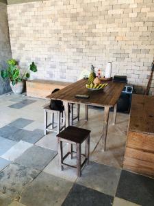 a wooden table with a bowl of fruit on it at Casa Liria Gael - Kite Is Surf School in Jericoacoara +9 photos