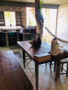 a wooden table in a kitchen with a tree at Casa Liria Gael - Kite Is Surf School in Jericoacoara