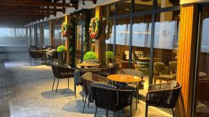 a group of tables and chairs in a restaurant at Bela Reka C320 Kopaonik Brzece in Brzeće