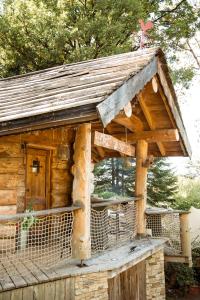 a wooden cabin with a roof on a porch at Les Cabanes Du Saleve in Collonges-sous-Salève