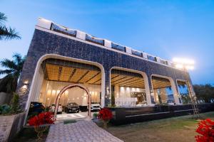 a large building with a large window at Pride Premier Alwar - Sariska in Alwar