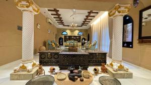 a lobby with a table and chairs in a room at Aryaf hostel in Nizwa
