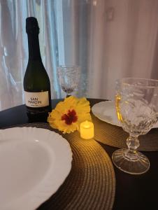 a table with a bottle of wine and two glasses at Vila Mar Lofts in Barra Velha