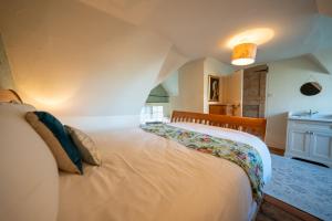 a bedroom with a large white bed in a room at The Old Rectory Framlingham in Framlingham