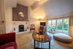 a living room with a coffee table and a fireplace at The Old Rectory Framlingham in Framlingham