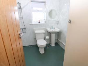 a bathroom with a toilet and a sink at Mains Cottage in Consett +32 photos