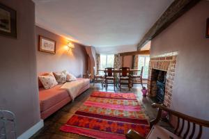 a living room with a couch and a fireplace at The Old Rectory Framlingham in Framlingham