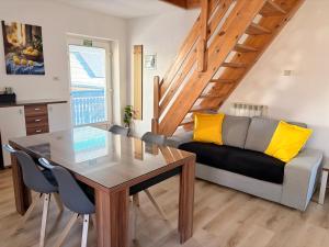 a living room with a table and a couch at Apartments Rupnik in Bovec