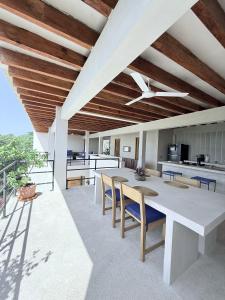 Villa Cuachalalate - Puerto Escondido في El Puertecito: مطبخ خارجي وغرفة طعام مع طاولة وكراسي