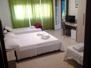 Posteľ alebo postele v izbe v ubytovaní Olimpica Relais guest house