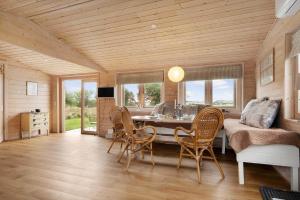 a kitchen with a dining room with a table and chairs at 20158-Samso-Laerkevej-13 in Mårup