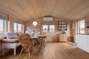 a kitchen and dining room with a table and chairs at 20158-Samso-Laerkevej-13 in Mårup