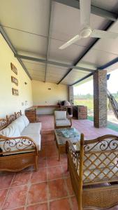 a living room with couches and a table at Cerquita del Cielo in San Bernardino
