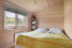a bedroom with a bed in a room with a window at 20158-Samso-Laerkevej-13 in Mårup