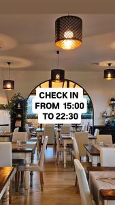 a restaurant with a sign that reads check in from to at Airone Pisa Hotel Ristorante in Pisa