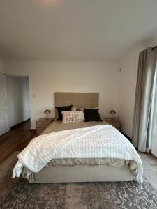 a bedroom with a large bed and two night stands at Serenity Green House near Constantia Winelands in Square Hill