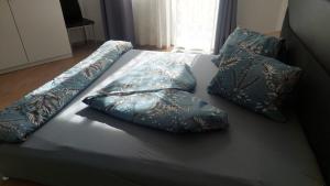 a bed with three pillows on top of it at Apart Stefan Niederthai in Niederthai