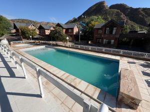 a large swimming pool in front of a house at Cabañas 4 Cascadas in San Rafael