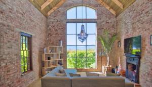 a large living room with a couch and a fireplace at Winelands Manor Vineyard Views in Riebeek-Kasteel