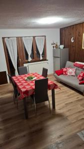 a living room with a table and a couch at Petit Maison - Valtournenche in Valtournenche
