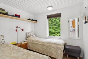 a bedroom with two beds and a window at LF18116-Veslos-Agerovej-6 in Amtoft