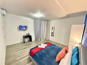 a bedroom with a bed and a couch and a tv at Casa Raffinata in Mestre +15 photos