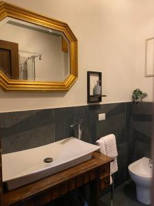 a bathroom with a sink and a mirror at Casa di Gea in Biella +8 photos
