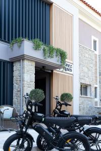 two motorcycles parked in front of a building at Ennea Muses Rooms and Suites in Nafplio