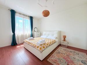 a bedroom with a white bed and a rug at Casa Milla - 15 min from airport, private sauna, terrace and parking in Alzano Lombardo