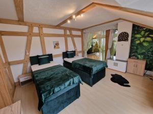 a bedroom with two beds in a room at Ferienwohnung Schwarzer Kater in Wiesenbronn