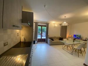 a kitchen and living room with a couch and a table at Appartamento Catalina in Saint-Pierre